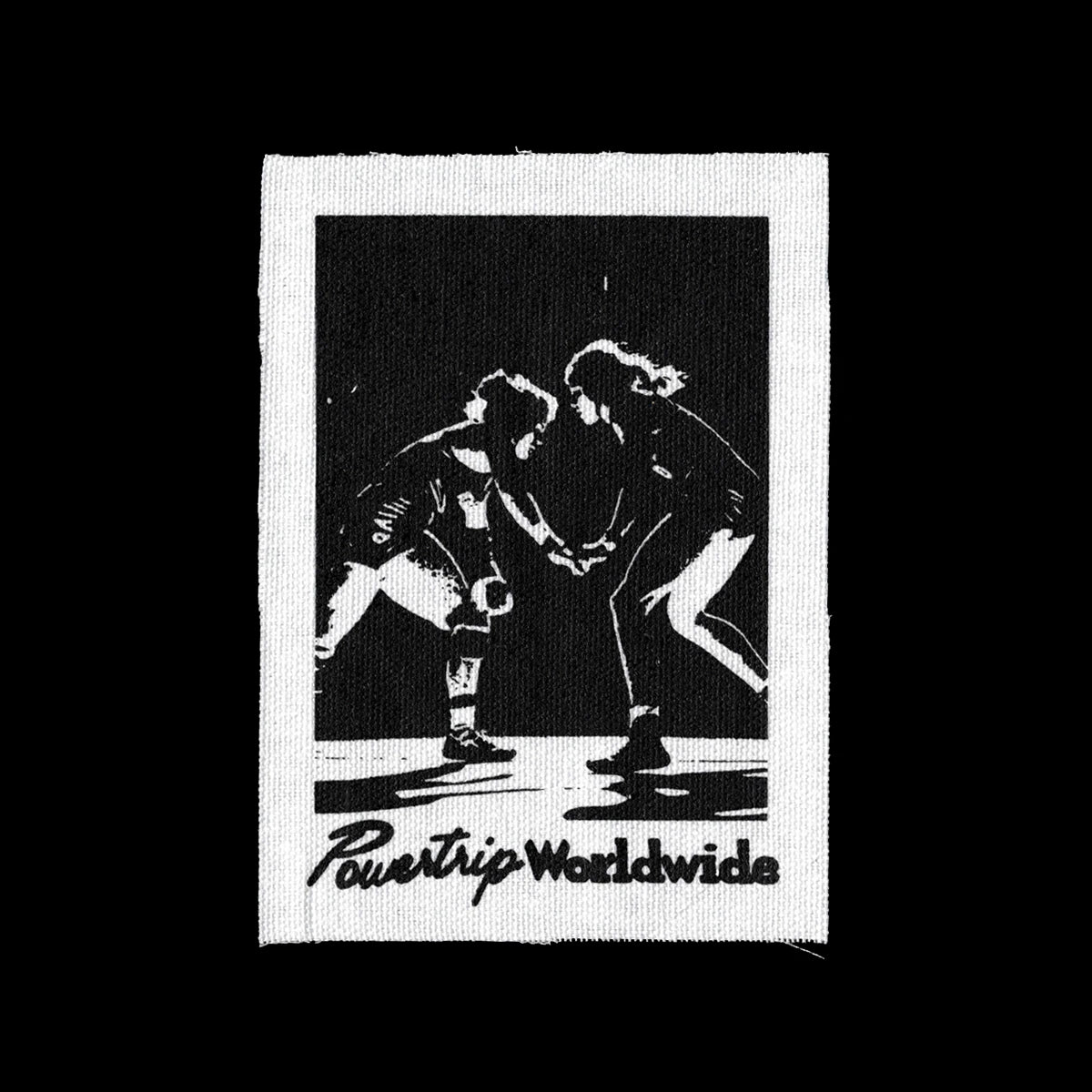 White canvas patch with black screen print of women wrestling. Text reads "Powertrip Worldwide".